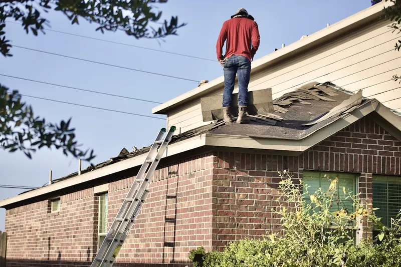 Professional roofer working on a residential roof in Saddle Up Estates